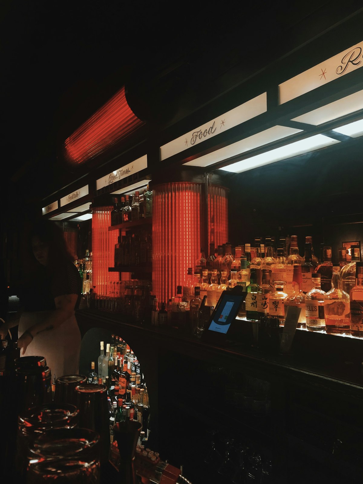 Bar interior with warm backlighting and exposed brick